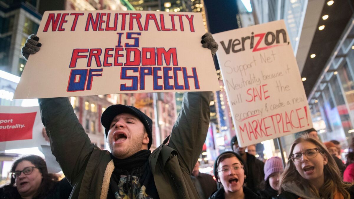 Demonstrators rally in support of net neutrality outside a Verizon store in New York on Dec. 7.