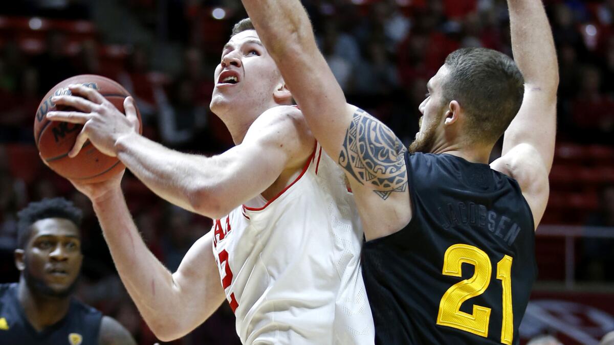Utah forward Jakob Poeltl tries to power his way to the basket against Arizona State forward Eric Jacobsen during the first half Thursday night.