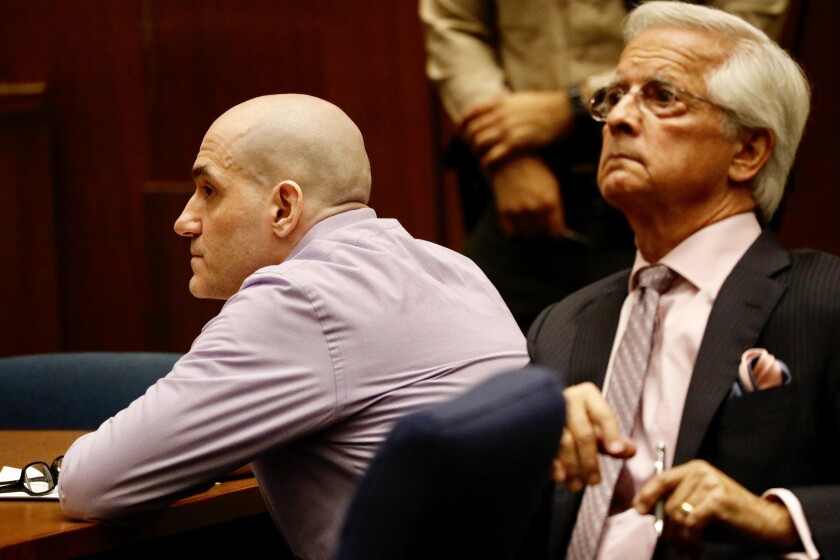 Michael Garguilo listens with his attorney Daniel Nardoni as guilty verdicts are read in a downtown Los Angeles courtroom.