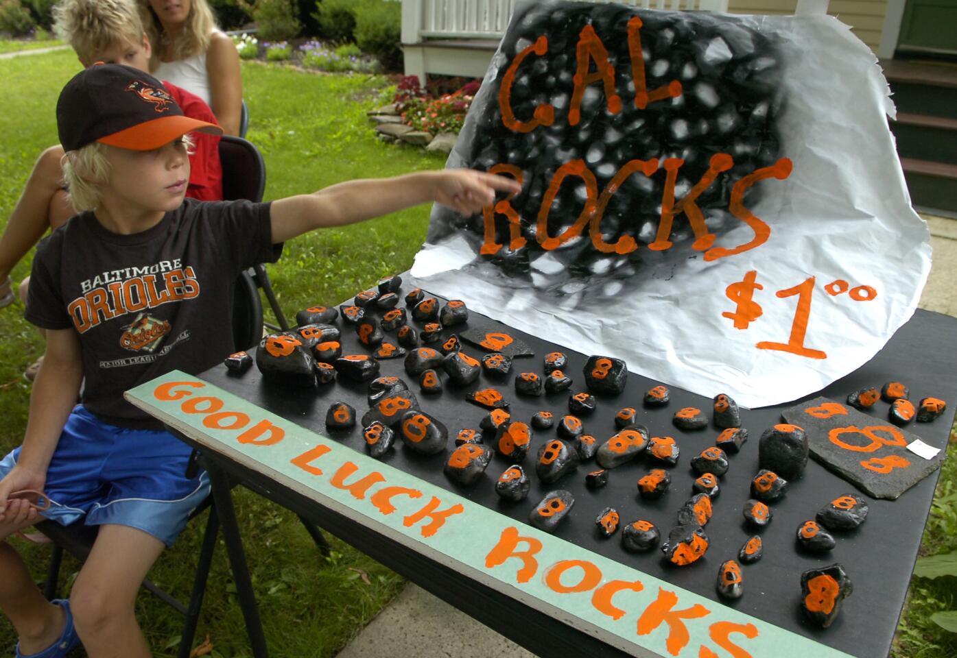 Ted Mebust, 7, of Cooperstown selling his handmade "Cal Rocks" on the route heading to where Cal Ripken Jr. and Tony Gwynn were to be inducted into the Baseball Hall of Fame.