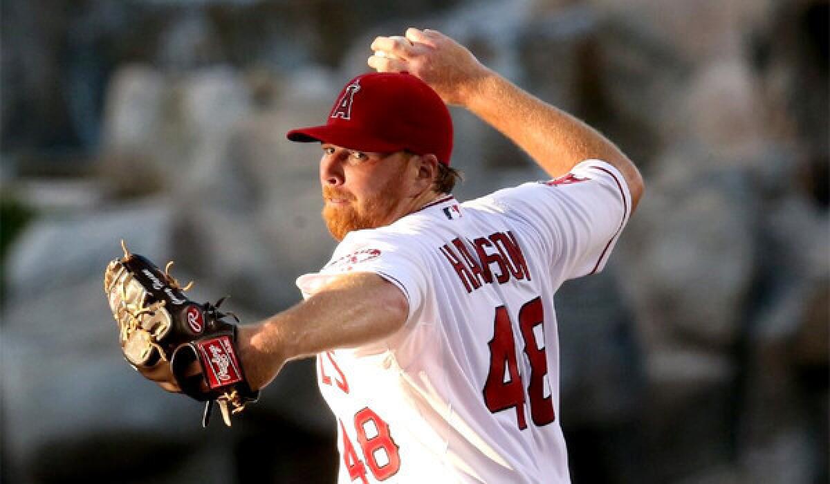 Tommy Hanson was scratched from a start for the Angels against the Detroit Tigers because of tightness in his right forearm.