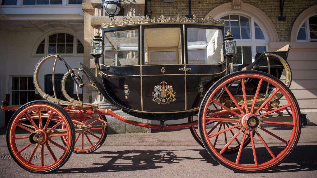 The Scottish State Coach, which will be used in the case of wet weather, for the wedding of Britain's Prince Harry and Meghan Markle, while it is prepared for the special day, in the Royal Mews at Buckingham Palace in London on May 1.