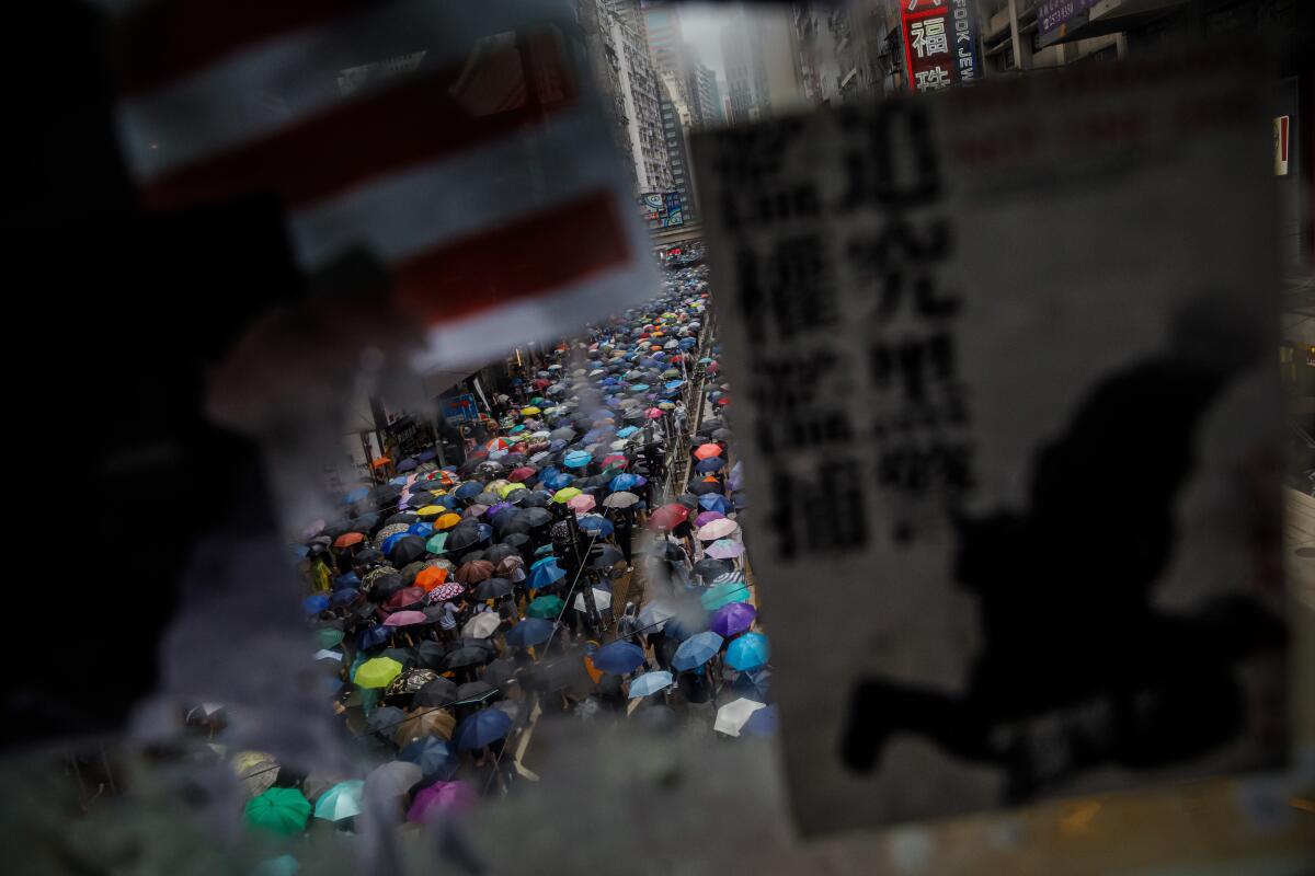 A protester uses a paper bag as a mask in a march in Hong Kong on Sunday.