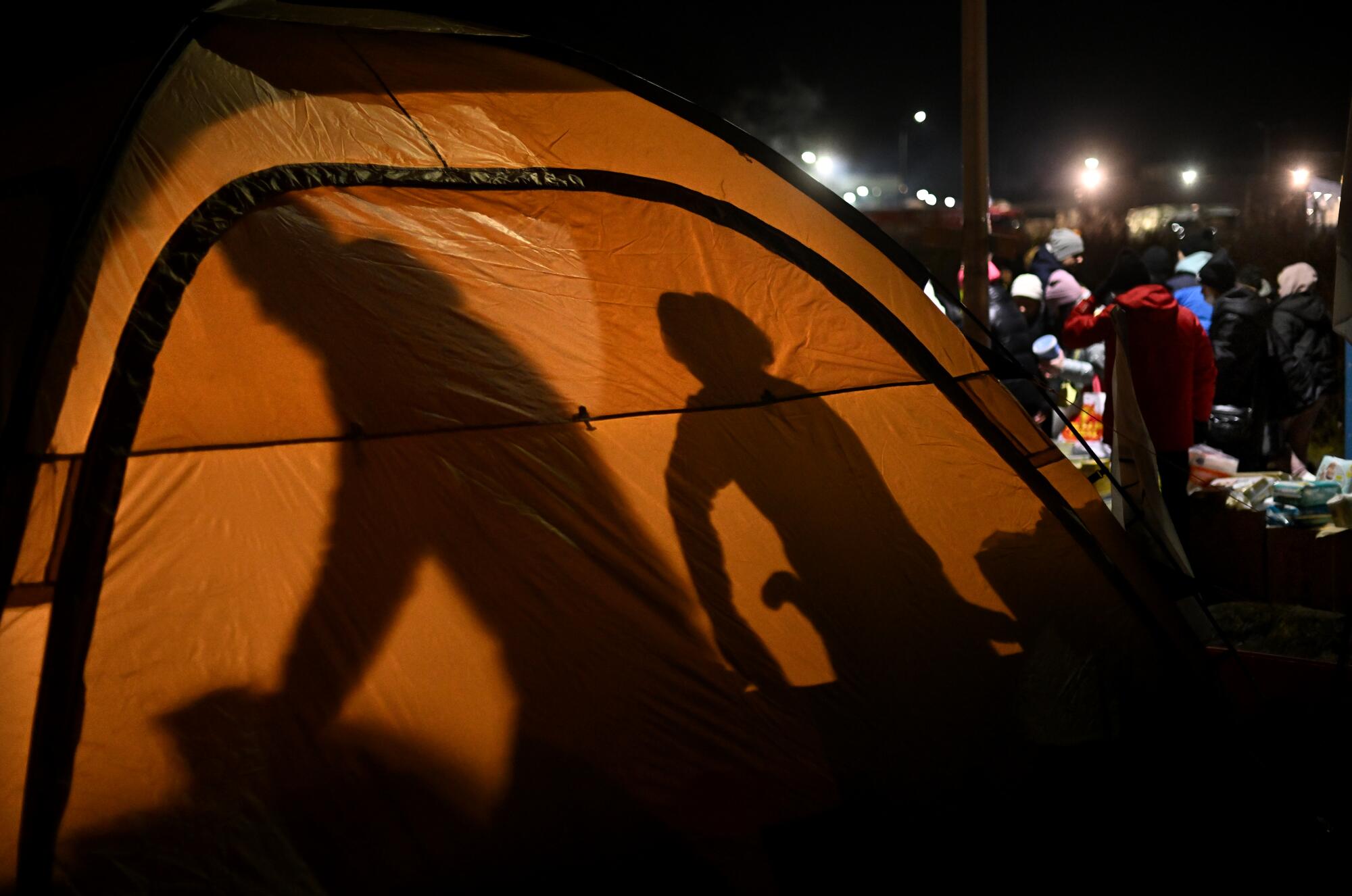 Volunteers work in a tent in Medyka, Poland