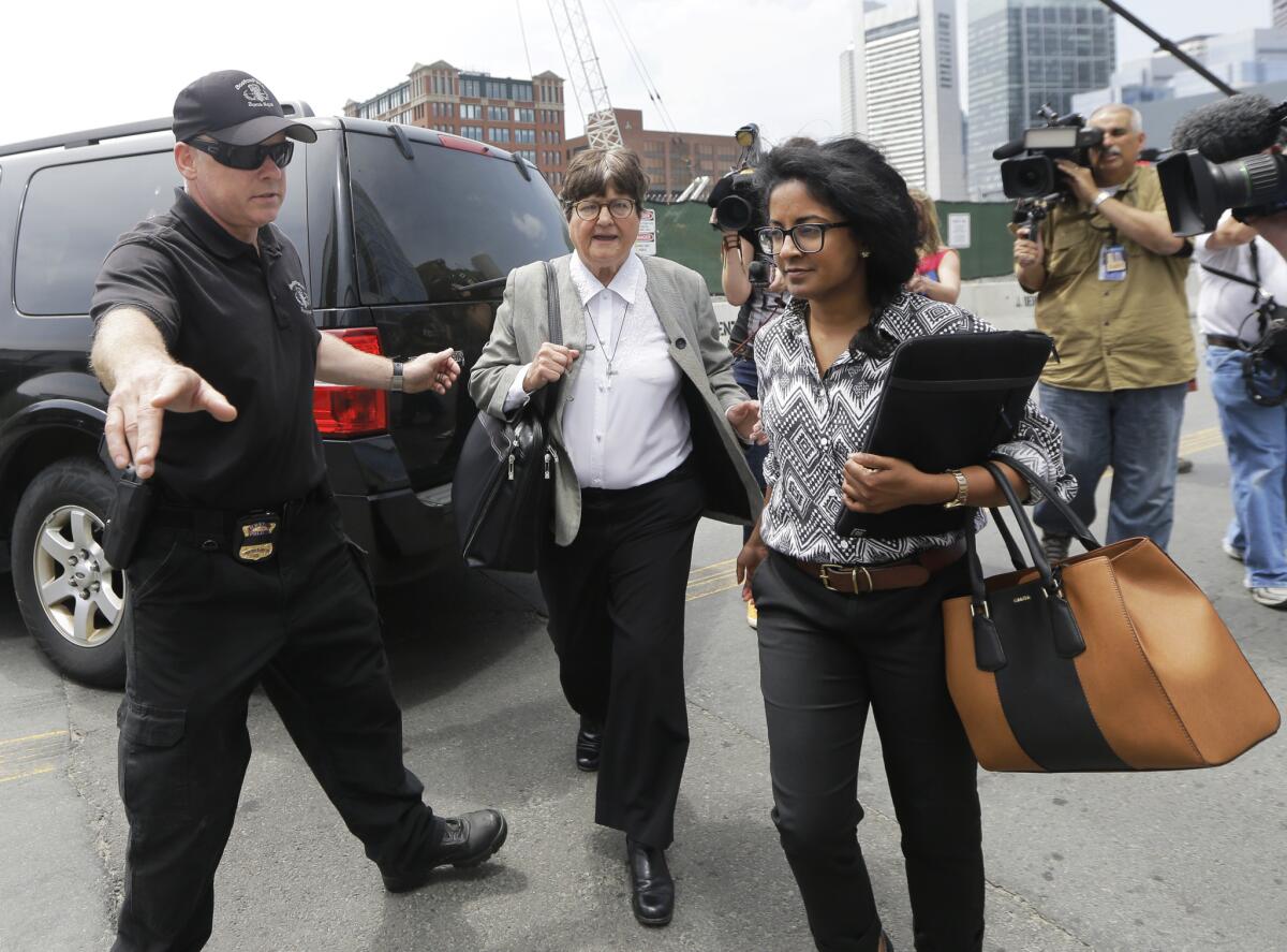 A member of the Boston Police Bomb Squad points the way for death penalty opponent Sister Helen Prejean, middle, as she departs federal court in Boston after testifying during the penalty phase in Dzhokhar Tsarnaev's trial Monday, May 11, 2015.