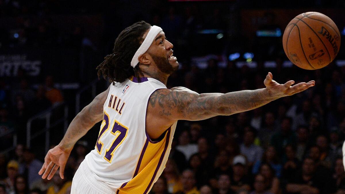 Lakers forward Jordan Hill reaches for a rebound during a win over the Boston Celtics on Feb. 22, 2015.