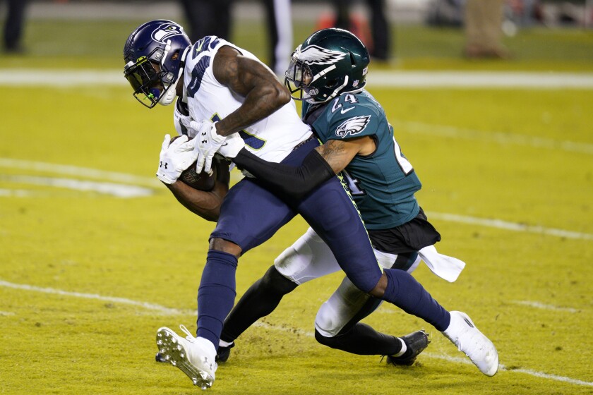 Seattle Seahawks' DK Metcalf is tackled by Philadelphia Eagles' Darius Slay.