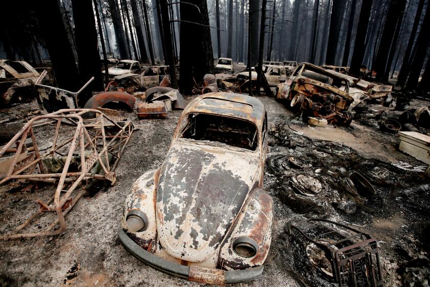 Aug. 18: The Caldor Fire leaves a moonscape of burnt forest, homes and vehicles in the unincorporated El Dorado County community of Grizzly Flats. (Luis Sinco / Los Angeles Times)