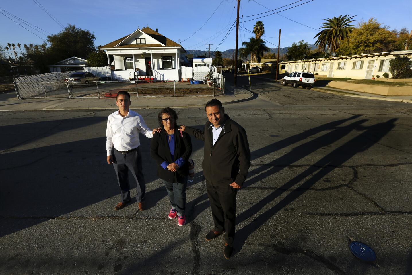 Rosa Murillo and her sons, real estate agents Ricardo Ponce, left, and Jose Ponce, in the neighborhood the brothers grew up in on the west side of San Bernardino.