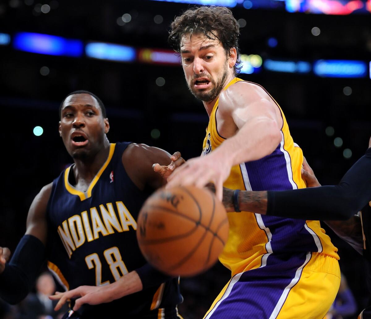 Lakers center Pau Gasol battles for a loose ball with Indiana Pacers center Ian Mahinmi during the Lakers' 104-92 loss at Staples Center.