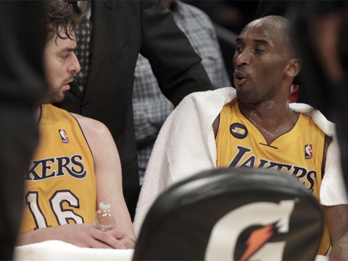 Pau Gasol, left, and Kobe Bryant talk during a timeout Tuesday night at Staples Center.