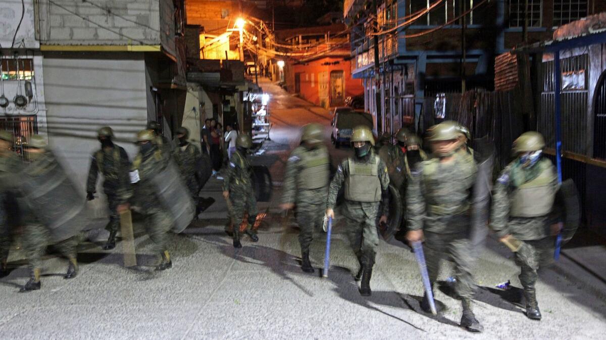 Soldiers patrol a street in Tegucigalpa, Honduras, on Dec. 12.