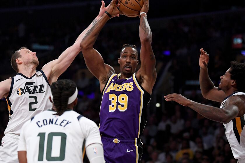 LOS ANGELES, CALIFORNIA - OCTOBER 25: Dwight Howard #39 of the Los Angeles Lakers grabs a rebound in front of Ed Davis #17 and Mike Conley #10 of the Utah Jazz, as he is fouled by Joe Ingles #2, during the first half at Staples Center on October 25, 2019 in Los Angeles, California. (Photo by Harry How/Getty Images) ** OUTS - ELSENT, FPG, CM - OUTS * NM, PH, VA if sourced by CT, LA or MoD **