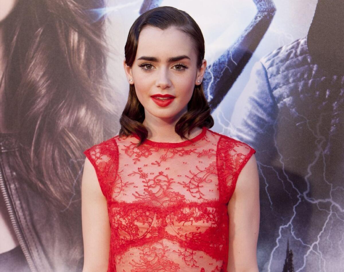 English actress Lily Collins, shown at the premiere of the film "The Mortal Instruments: City of Bones," leads McAfee's list of "most dangerous" cyber celebrities -- figures whose popularity is used by hackers to trick fans into downloading malware.