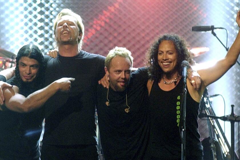**ADVANCE FOR SUNDAY, AUG. 20--FILE** From left, Robert Trujillo, James Hetfield, Lars Ulrich and Kirk Hammett of Metallica take a bow following their performance at the close of "MTVIcon: Metallica," a tribute to the band, at Universal Studios in Universal City, Calif., Saturday, May 3, 2003. Bob Seger turned the page. Metallica finally found justice for all its online fans. Now there are only a few remaining big-name musical acts who refuse to allow their music to be downloaded from the wildly popular iTunes Music Store. Digital music analysts say those holdouts, which include the Beatles, Led Zeppelin, Garth Brooks, Radiohead and Kid Rock, can't afford not to make an attempt to reach the masses of fans going online to buy music. The artists say, however, that they are getting only a small slice of digital profits and still believe in the concept of making a great album. (AP Photo/Chris Pizzello, File) ORG XMIT: DT107