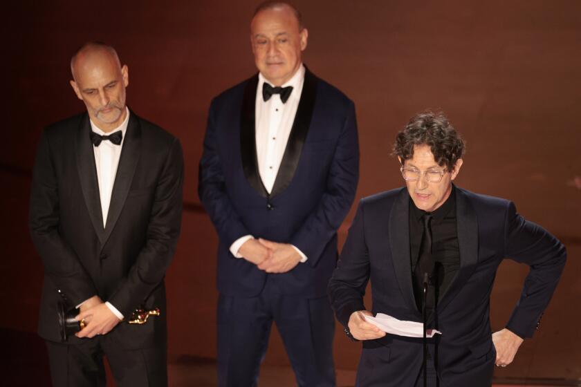 Hollywood, CA - March 10: Johnathan Glazer, right, during the live telecast of the 96th Annual Academy Awards in Dolby Theatre at Hollywood & Highland Center in Hollywood, CA, Sunday, March 10, 2024. (Myung J. Chun / Los Angeles Times)