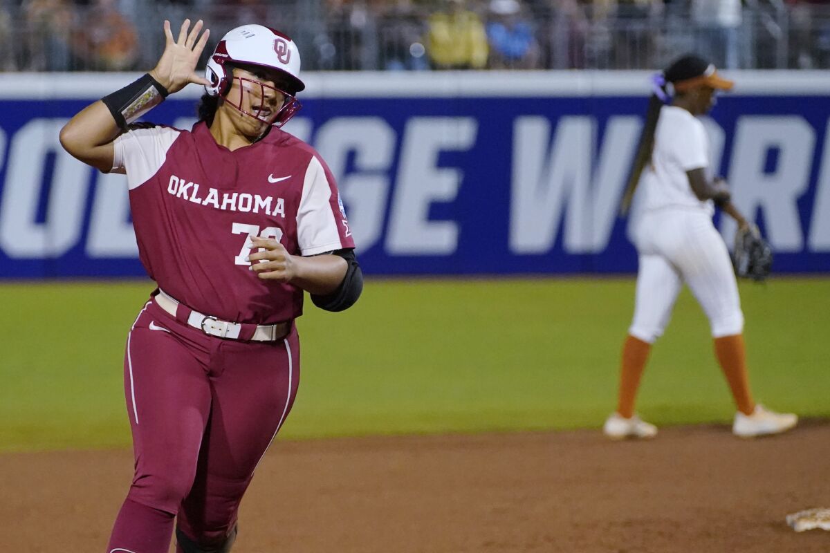 Oklahoma's Jocelyn Alo (78) gestures to fans as she runs the bases on a home run against Texas during the fifth inning of the first game of the NCAA Women's College World Series softball finals Wednesday, June 8, 2022, in Oklahoma City. (AP Photo/Sue Ogrocki)