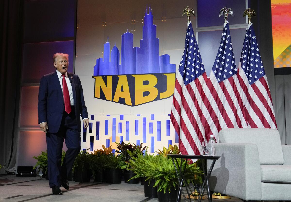 Donald Trump walks onto the NABJ convention stage.