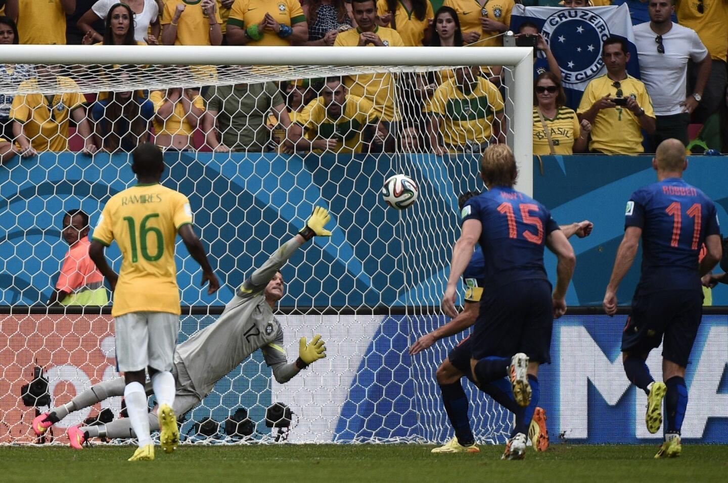 Brazil goalkeeper Julio Cesar can't stop a penalty kick by the Netherlands' Robin van Persie from finding the back of the net during the Netherlands' 3-0 win in the third-place match of the 2014 World Cup.