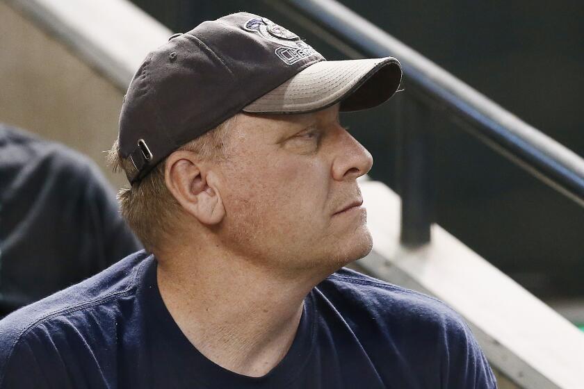Former pitcher Curt Schilling watches a game between the Arizona Diamondbacks and the San Francisco Giants