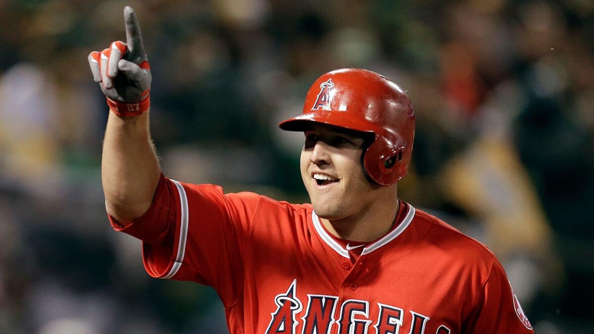 The Angels' Mike Trout celebrates after hitting a two-run home run against Oakland on Monday.