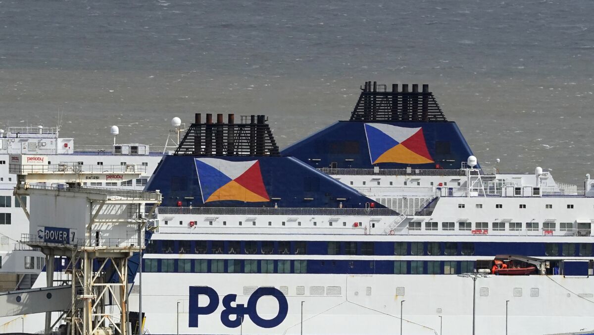 Two P&O ferries remain in the Port of Dover, in Folkestone, England, Friday, April 1, 2022. Britain has launched a criminal investigation has begun into P&O Ferries after the company fired almost 800 U.K.-based crew without warning so they could be replaced by cheaper contract staff. Business Secretary Kwasi Kwarteng said Friday that the Insolvency Service had opened ”formal criminal and civil investigations.” (Gareth Fuller/PA via AP)