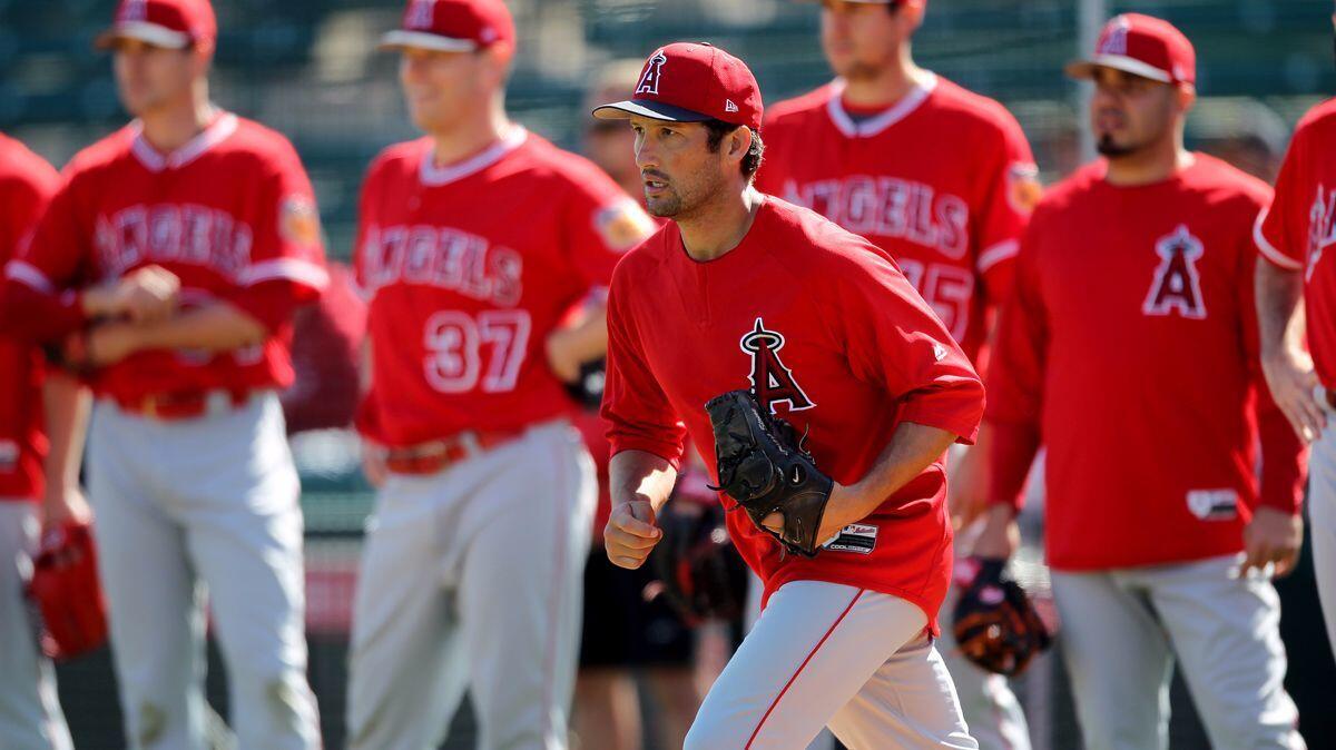 Angels relief pitcher Huston Street (16) runs out to the mound for an infield drill during spring training at Tempe Diablo Stadium in Tempe, Ariz., on Feb. 24.