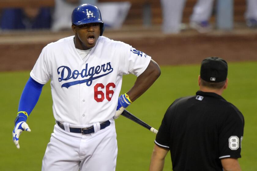 Yasiel Puig confronts plate umpire David Rackley after being called for a third strike during the third inning of the Dodgers' 1-0 win over the San Diego Padres at Dodger Stadium on Saturday. Rackley ejected Puig moments later.