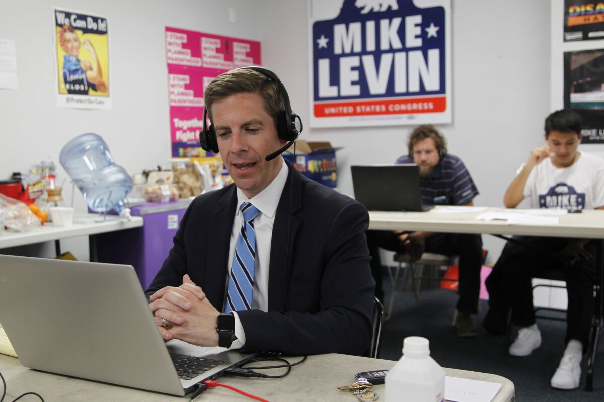 Mike Levin, congressional candidate for the 49th District, takes to the phones to call voters late on Election Day in Vista, California.