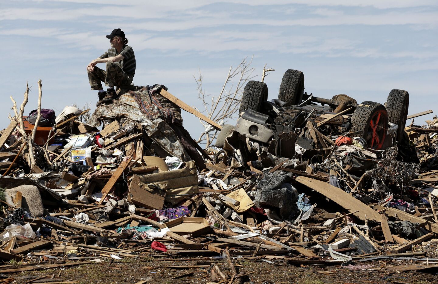David Lee Estep sits atop a pile of rubble that was the home he shared with his parents in Moore, Okla., three days after a huge tornado roared through the suburb, flattening a wide swath of homes and businesses.