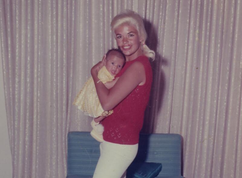 A baby being held by a woman