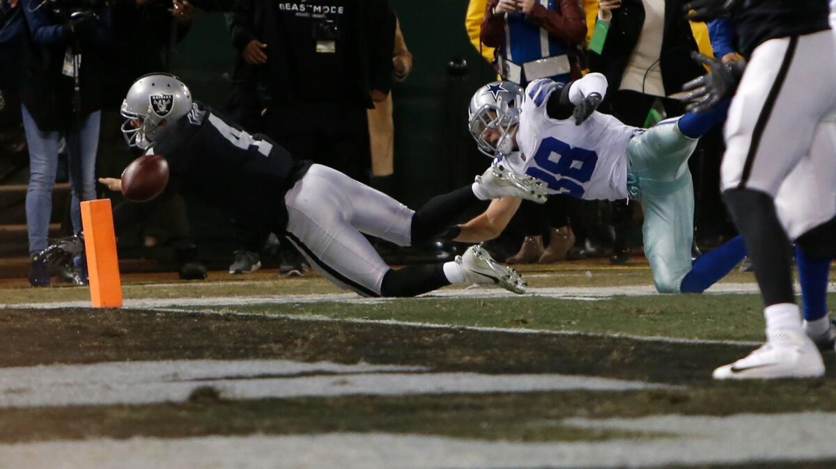 Derek Carr of the Oakland Raiders fumbles the ball into the end zone for a Dallas Cowboys touchback in the fourth quarter.