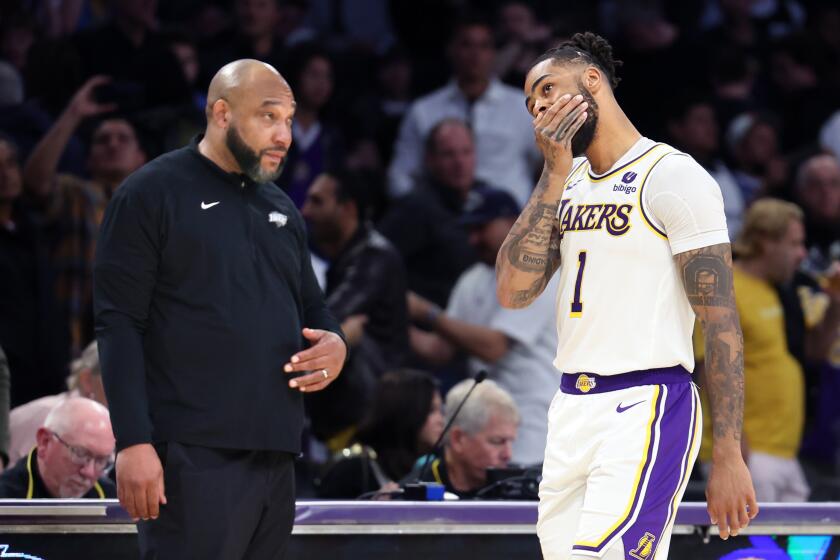 Los Angeles, California March 2, 2024-Lakers D'Angelo Russell walks past head coach Darvin Ham.