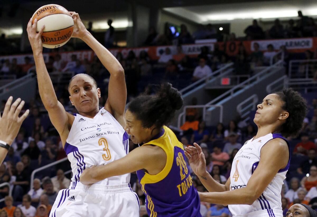 Phoenix's Diana Taurasi grabs a rebound over the Sparks' Kristi Toliver during the first half of the Mercury's 75-72 win Friday in the first game of a WNBA playoff series with Los Angeles.
