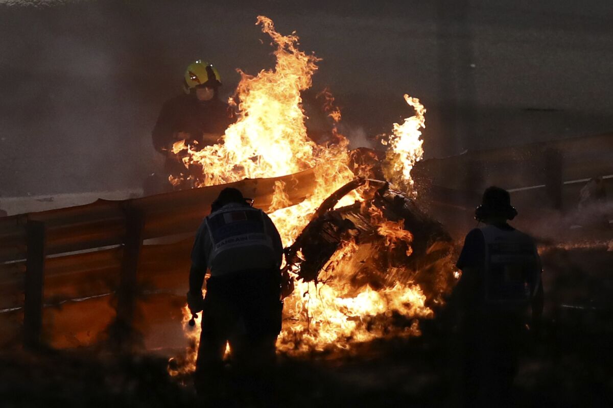 The parts of Haas driver Romain Grosjean's car is burning after he crashed during the Formula One race in Bahrain International Circuit in Sakhir, Bahrain, Sunday, Nov. 29, 2020. (Brynn Lennon, Pool via AP)