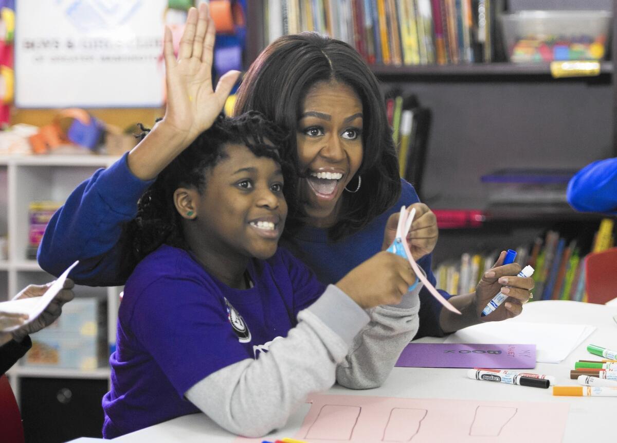 Michelle Obama participates in a literacy project at the Boys and Girls Club of Greater Washington in honor of Martin Luther King Jr. Day in Washington on Jan. 19, 2015.