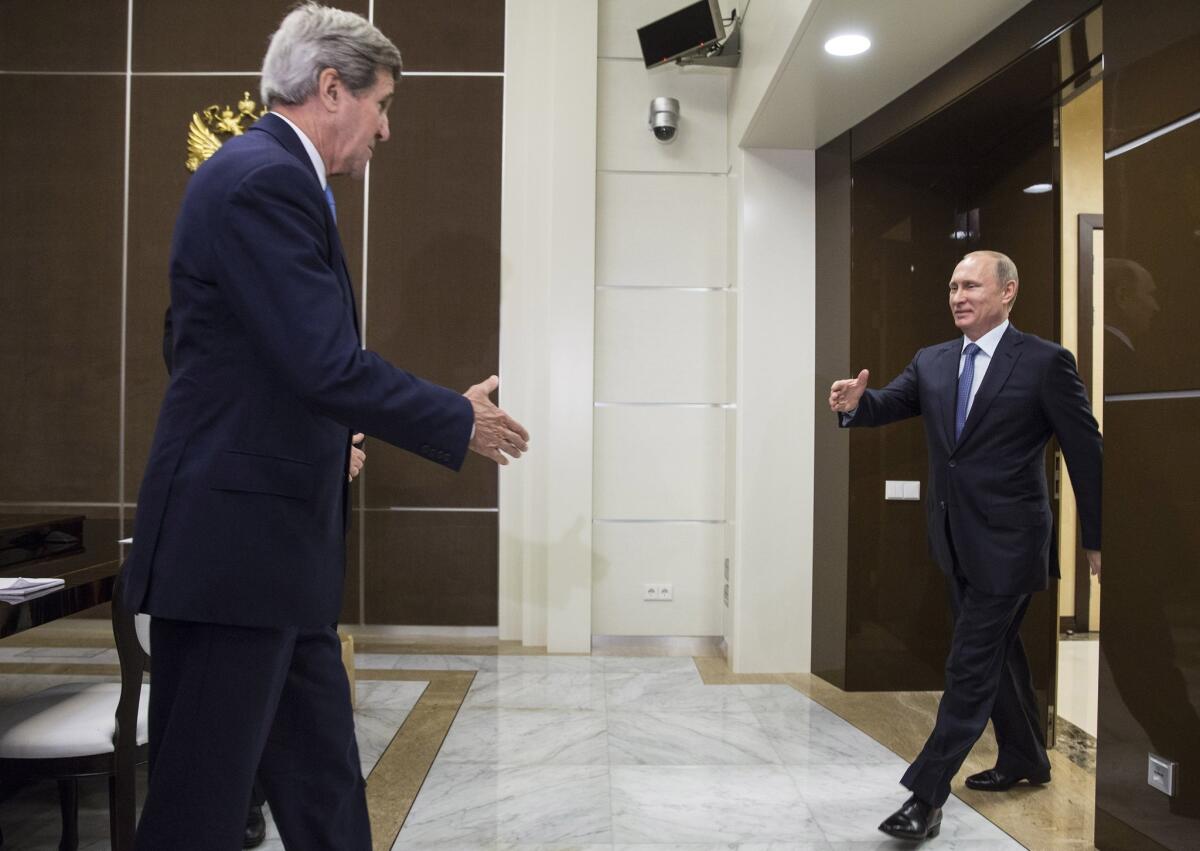 U.S. Secretary of State John F. Kerry is welcomed by Russian President Vladimir Putin at the presidential residence in Sochi, Russia, on Tuesday. It was their first meeting in two years.