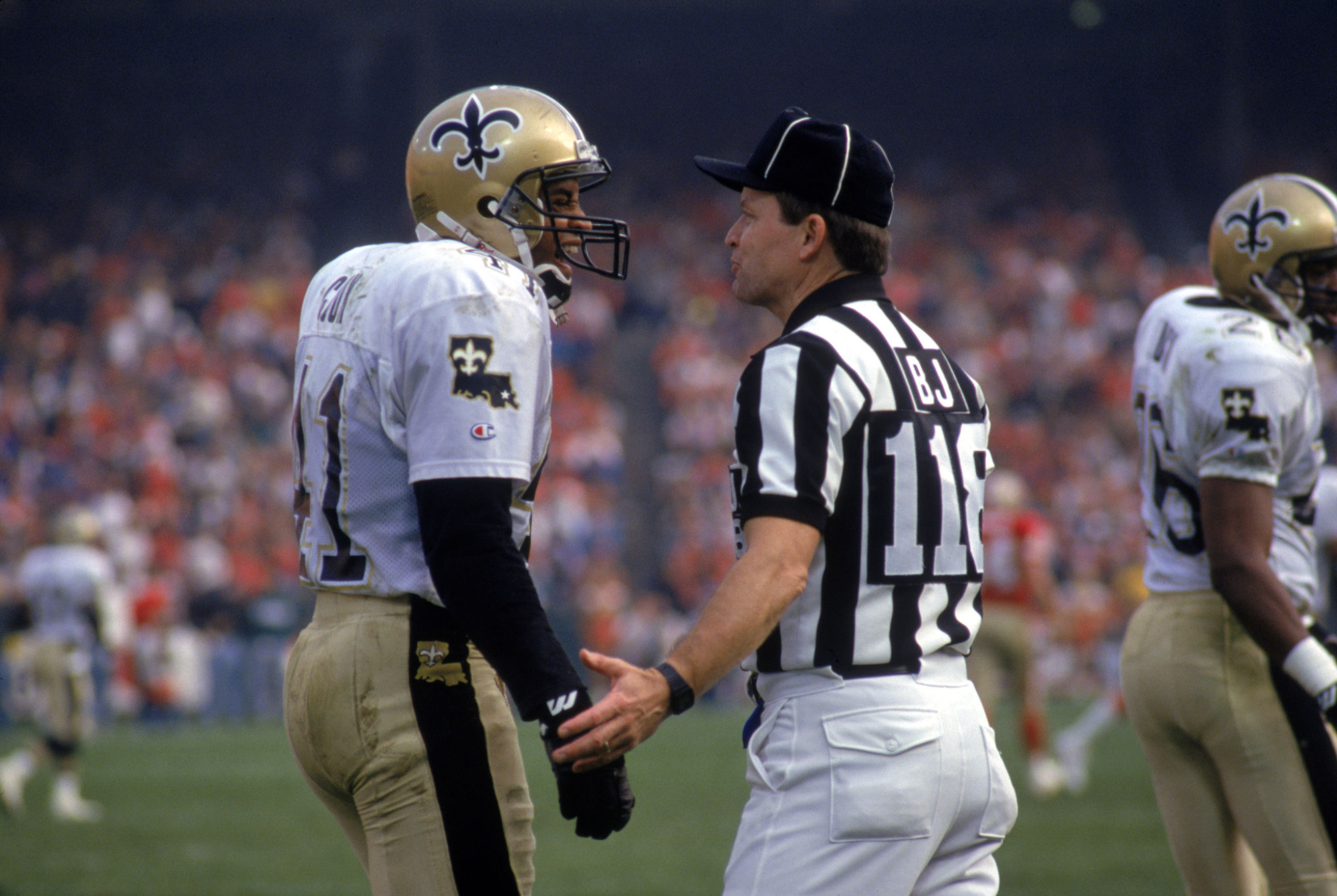 Back judge Tom Sifferman converses with New Orleans Saints cornerback Toi Cook.