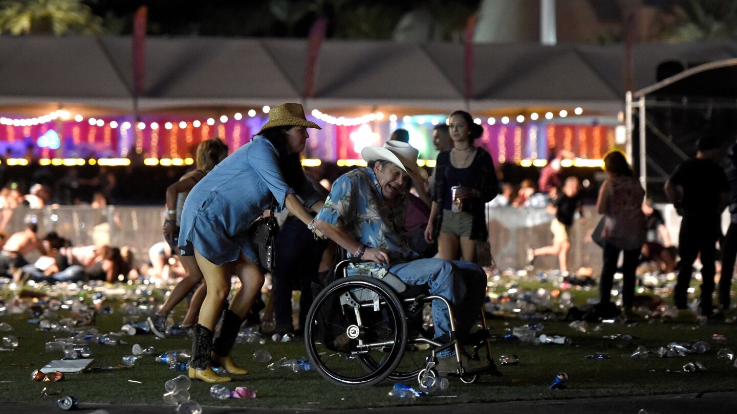 A man in a wheelchair is taken away from the Route 91 Harvest country music festival after gunfire was heard.