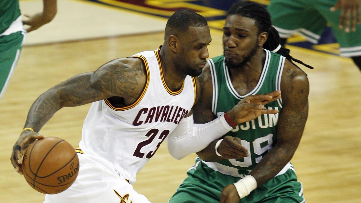 Cleveland Cavaliers forward LeBron James, left, tries to drive past Boston Celtics forward Jae Crowder during the Cavaliers' win in Game 1 of the Eastern Conference quarterfinals on Sunday.