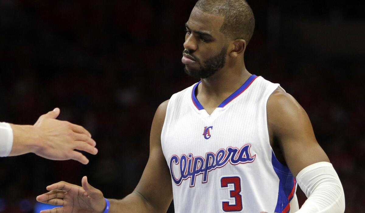 Clippers point guard Chris Paul is congratulated by a teammate after making two free throws to tie the score against the Spurs in Game 7.