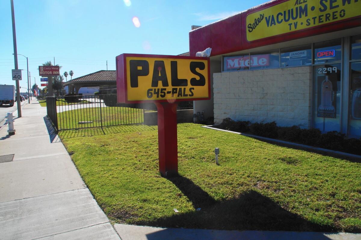 Owners of Pals Vacuum Sewing Center contend in a recent lawsuit that a new apartment complex intended to replace the Costa Mesa Motor Inn would affect the transmission ability of cellphone towers on the store's property.