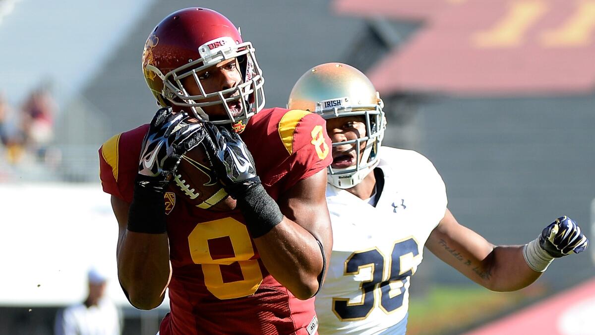 USC wide receiver George Farmer makes a catch in front of Notre Dame cornerback Cole Luke during the Trojans' victory at the Coliseum on Nov. 29, 2014.