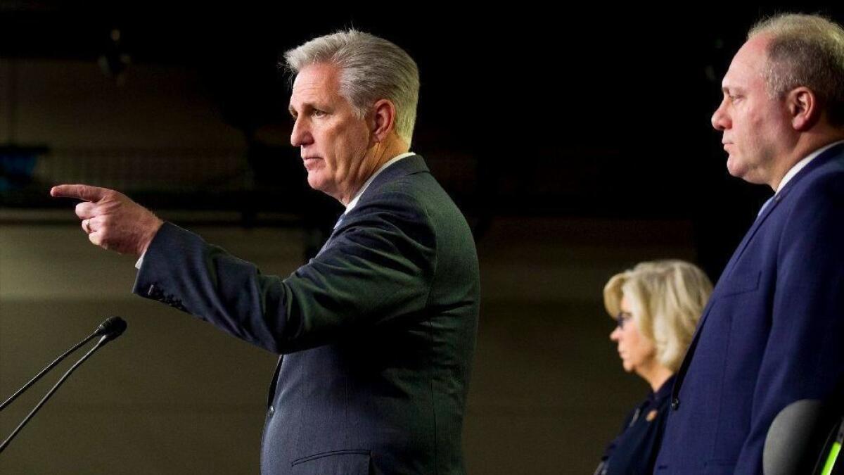 House Minority Leader Kevin McCarthy points to a questioner at a news conference, joined by Republican leadership lieutenants Reps. Liz Cheney and Steve Scalise.