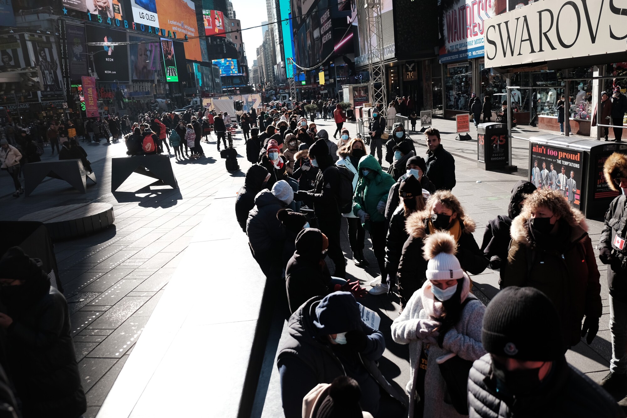 People wait in long lines in Times Square.