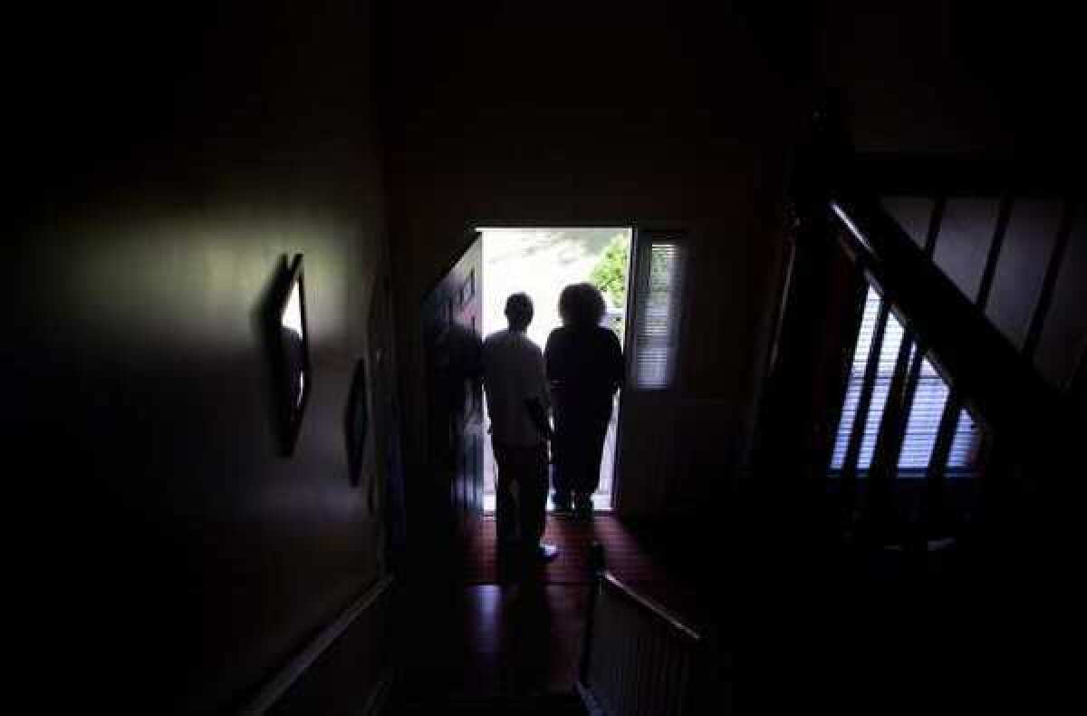 Michael and Patricia Jackson stand in the doorway of their home in Marietta, Ga.