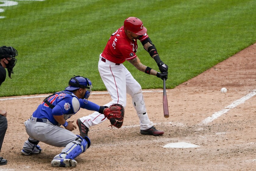 Cincinnati Reds' Nick Castellanos (2) hits a walkoff RBI single in the 10th inning during a baseball game against the Chicago Cubs in Cincinnati on Sunday, May 2, 2021. (AP Photo/Jeff Dean)