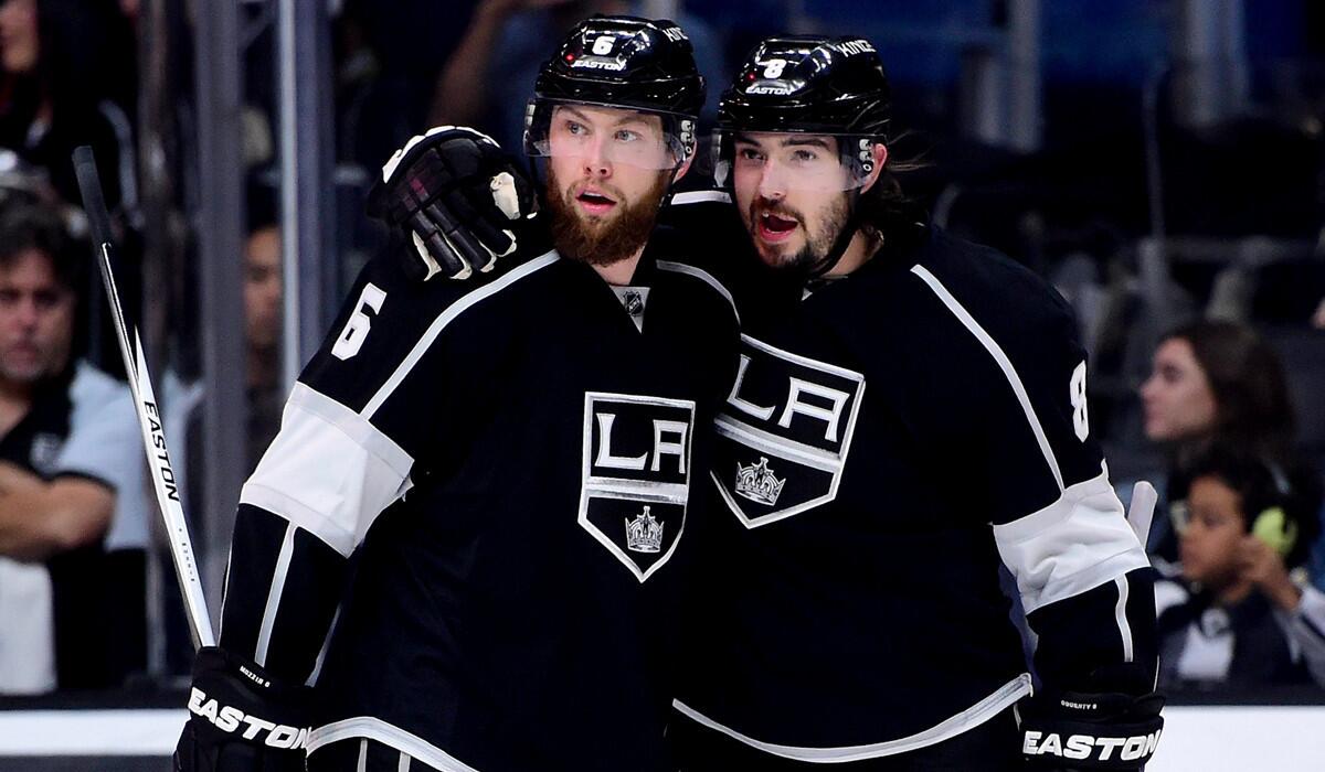 The Kings' Drew Doughty, right, celebrates his power play goal with teammate Jake Muzzin to take a 1-0 lead over the Pittsburgh Penguins during the second period at Staples Center on Saturday.