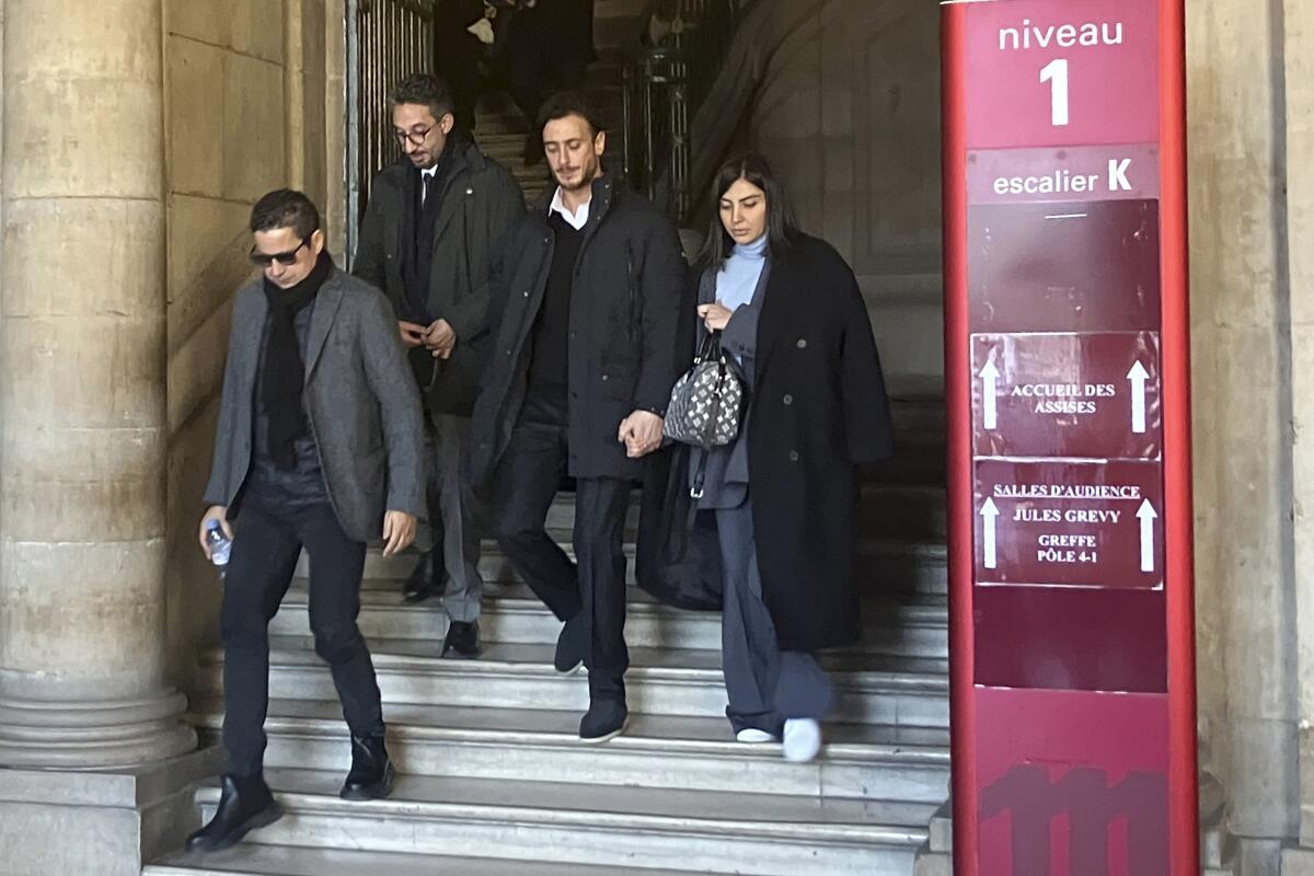 Moroccan singer Saad Lamjarred, second from right, leaves a court house in Paris