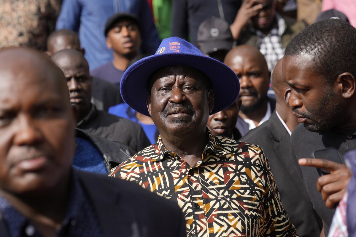 Kenyan presidential candidate Raila Odinga, center, departs after delivering an address to the nation at his campaign headquarters in downtown Nairobi, Kenya, Tuesday, Aug. 16, 2022. Kenya is calm a day after Deputy President William Ruto was declared the winner of the narrow presidential election over longtime opposition figure Raila Odinga. (AP Photo/Ben Curtis)